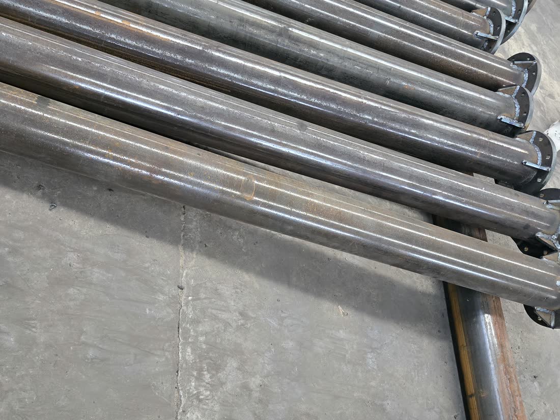 Galvanised structural tubes laid out in the workshop