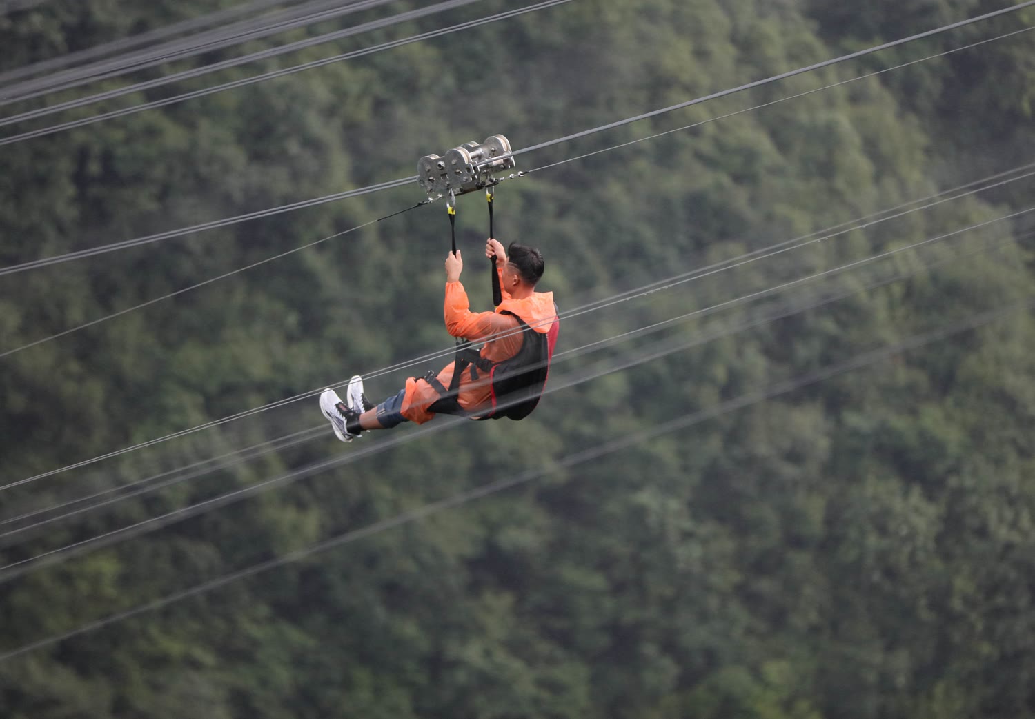 Wide view of a zipline station above a canyon